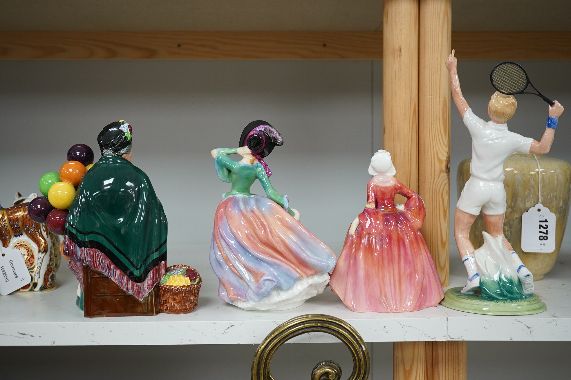 Four Royal Doulton figures to include The Ace HN 3398, Autumn Breezes HN 1911, Janet HN 1537 and The Old Balloon Seller HN 1315. Condition - good